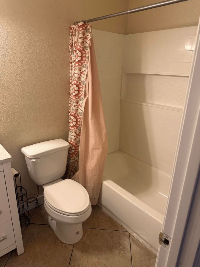 Spotless bathroom after a deep clean, toilet and tub gleaming