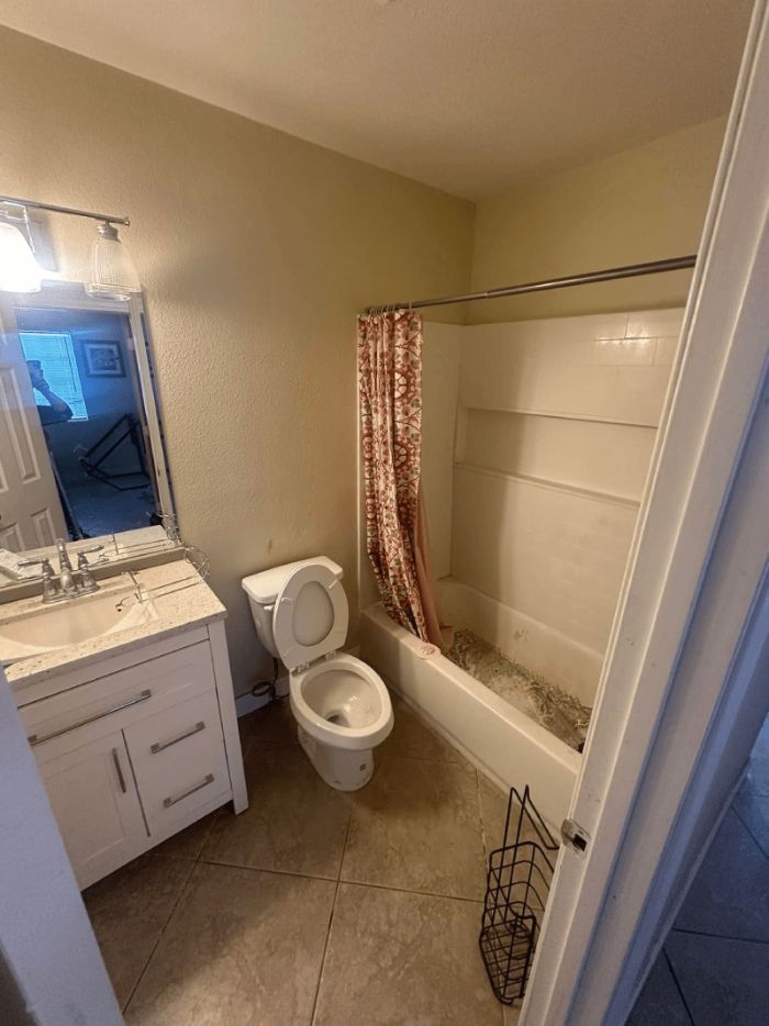 Freshly cleaned bathroom with vanity, toilet and tub