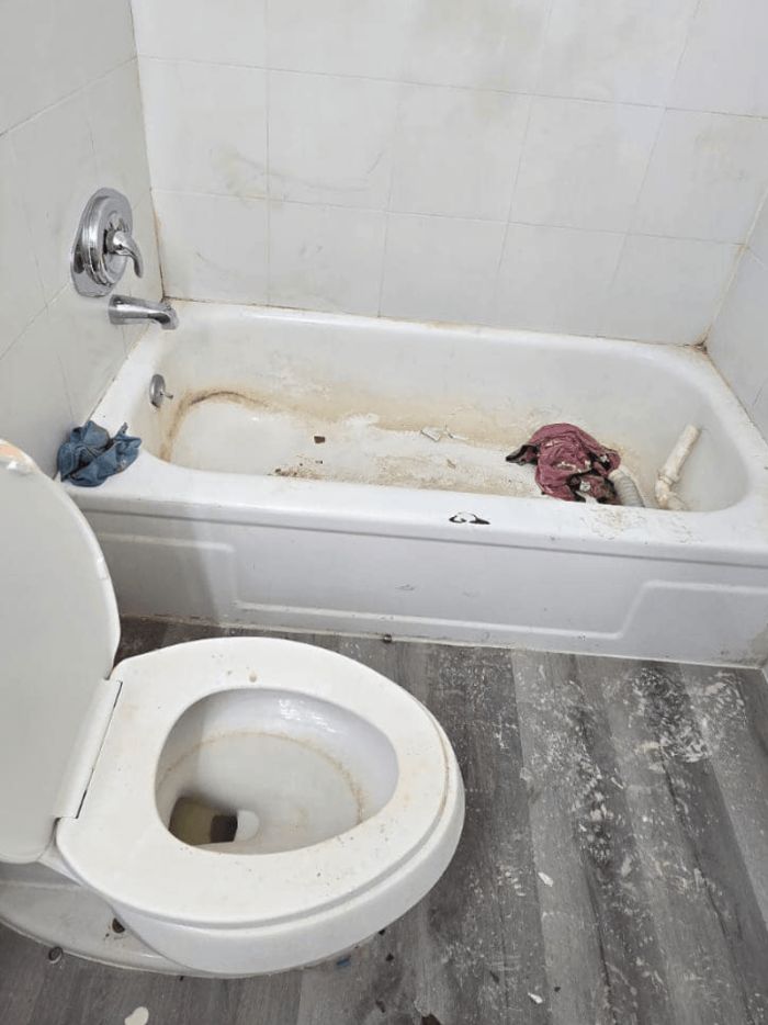 Bathtub before its deep clean, with heavy soap scum and grime