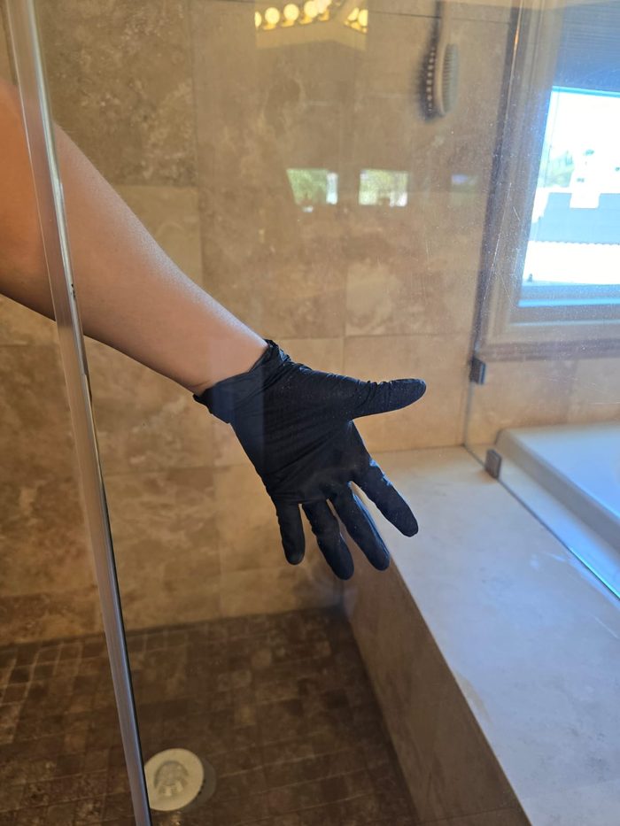 Crystal-clear glass shower door after a cleaning by Marce's Magic Eco Cleaning